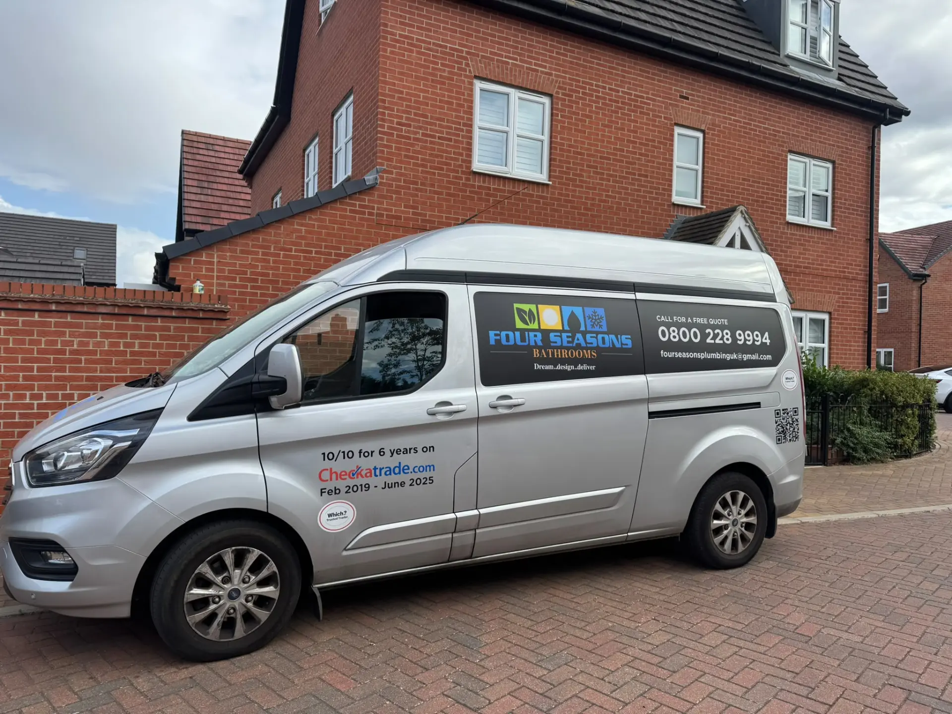 Four Seasons Bathrooms signwritten Ford Transit van parked outside a home in Bedfordshire